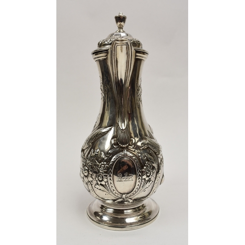 8012 - A George III silver hot water jug/coffee pot.  The body decorated in high relief with birds, flowers... 
