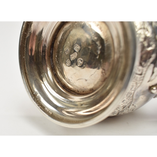 8012 - A George III silver hot water jug/coffee pot.  The body decorated in high relief with birds, flowers... 
