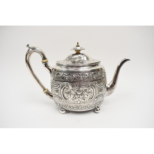 8013 - A George III matched silver three piece tea set of highly ornate form with all-over engraved and emb... 