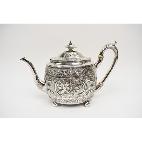 8013 - A George III matched silver three piece tea set of highly ornate form with all-over engraved and emb... 