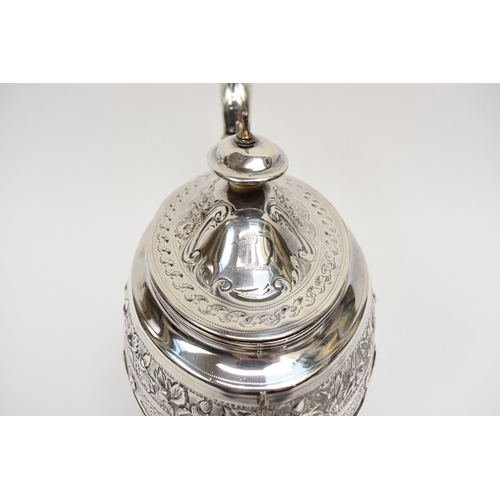 8013 - A George III matched silver three piece tea set of highly ornate form with all-over engraved and emb... 
