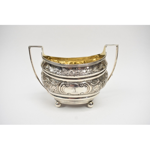 8013 - A George III matched silver three piece tea set of highly ornate form with all-over engraved and emb... 