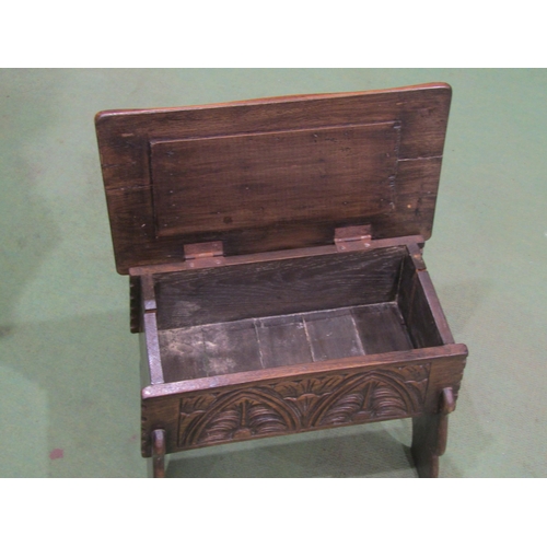 4006 - A mid-20th Century lidded oak stool, carved Gothic arch decoration, splits to sides. 44cm long x 27c... 