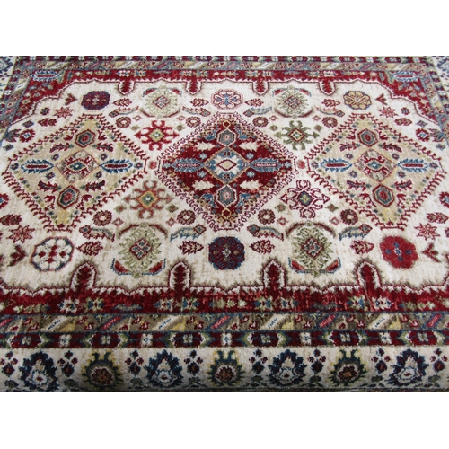 4011 - A modern wool rug, maroon and beige ground, central motif, patterned borders, fringed edges, 163cm x... 
