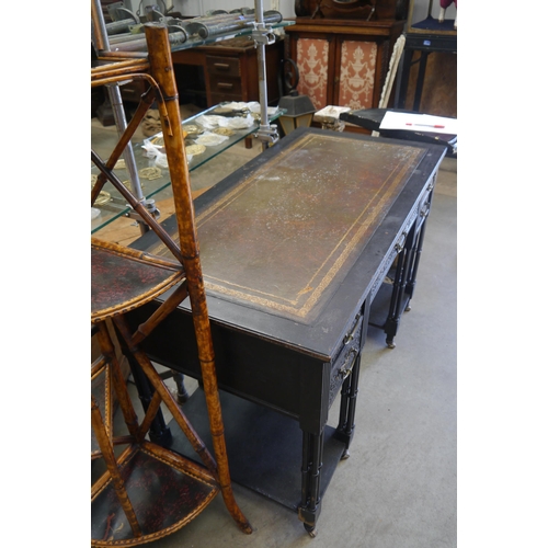 2006 - A Liberty of London leather topped faux bamboo desk on brass castors
