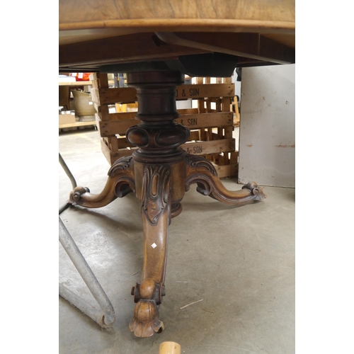 2029 - A 19th Century rosewood tilt-top dining table on carved column to tripod outswept legs, a/f