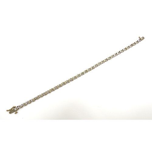 6015 - A 9ct gold diamond line bracelet, 0.50ct total, 18.5cm long, 6.1g