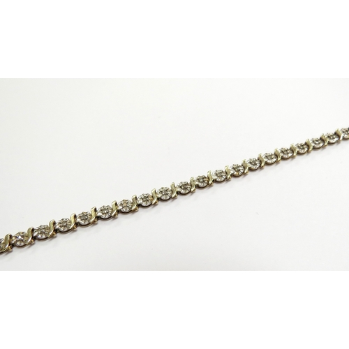 6015 - A 9ct gold diamond line bracelet, 0.50ct total, 18.5cm long, 6.1g