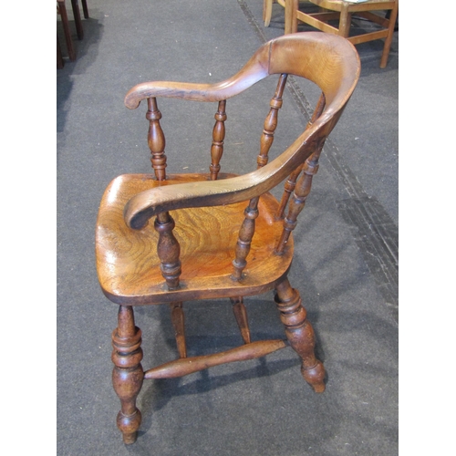 1018 - A circa 1900 elm seated oak smoker's bow chair, turned legs to 'H' stretcher base, backrest restored