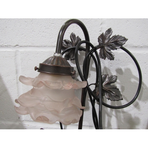 1027 - A modern table lamp as a seated cherub, floral frilled shade, 56cm tall