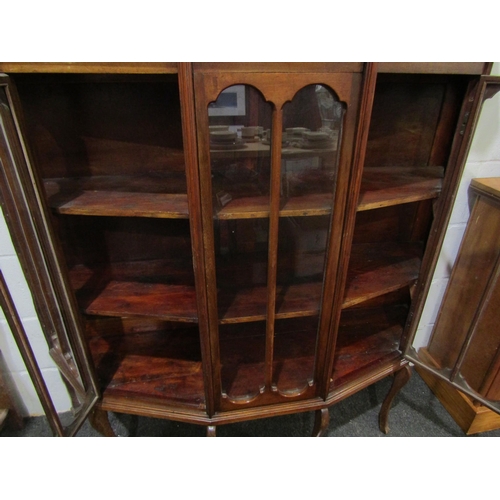 1032 - A 20th Century mahogany three tier display cabinet, canted corner front, on four cabriole fore legs,... 
