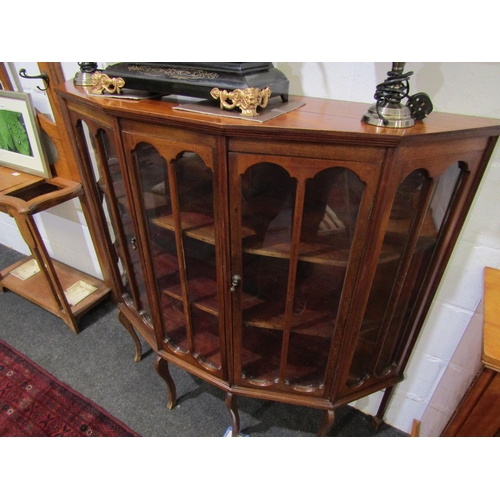 1032 - A 20th Century mahogany three tier display cabinet, canted corner front, on four cabriole fore legs,... 