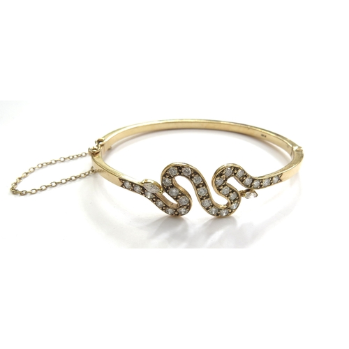 6014 - A diamond hinged bangle with snake like design, stamped 375, 18.7g