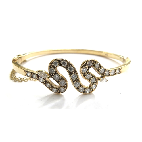 6014 - A diamond hinged bangle with snake like design, stamped 375, 18.7g