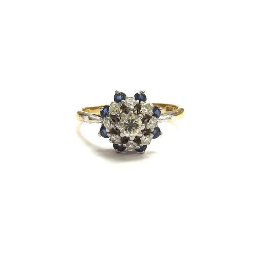 6062 - An 18ct gold platinum set sapphire and diamond cluster ring. Size Q, 4.2g