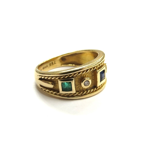 6044 - An 18ct gold band with square sapphire flanked by round diamonds and square emeralds all in raised c... 
