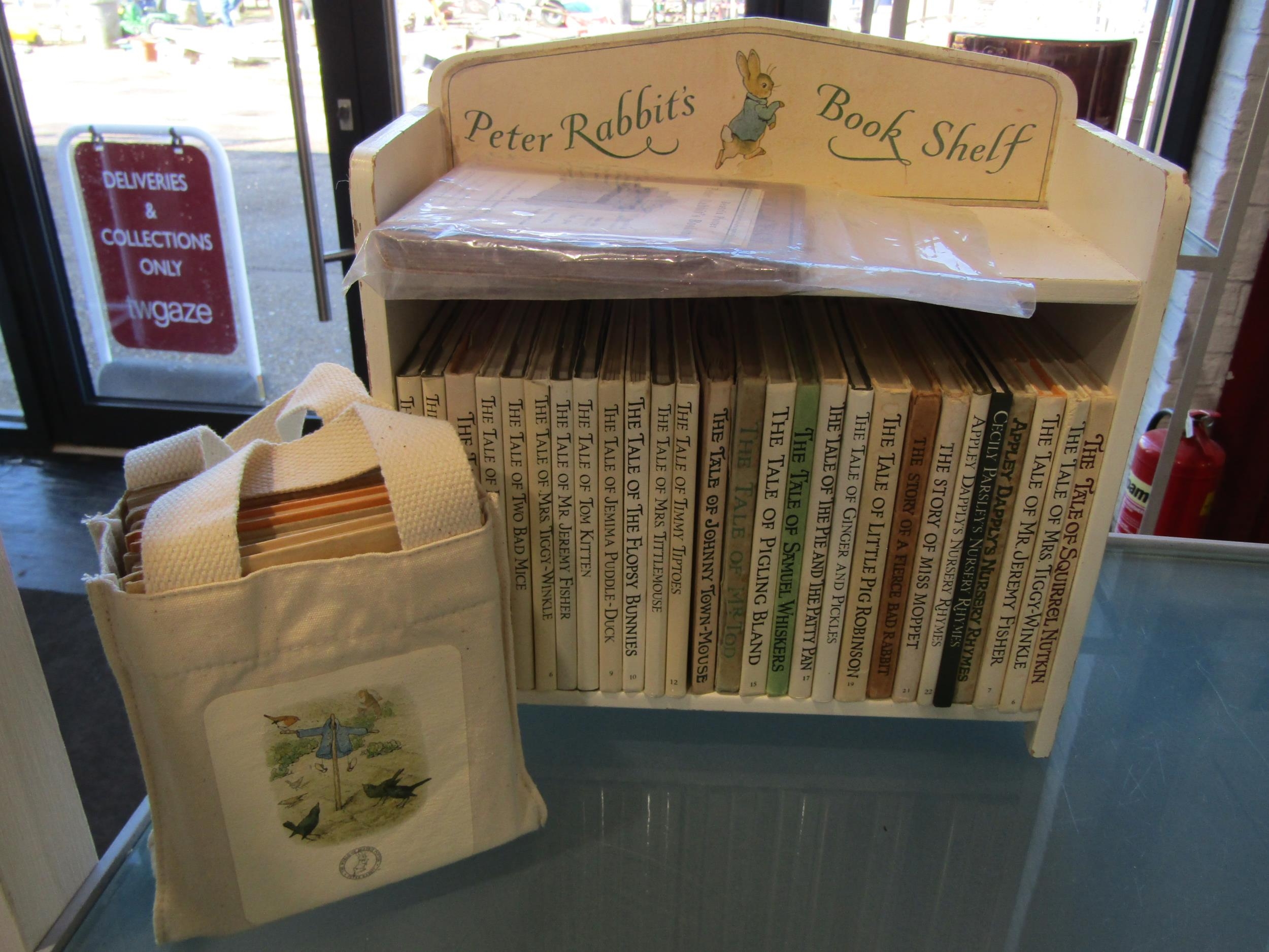 A Peter Rabbit's bookshelf with complete set of books including early ...