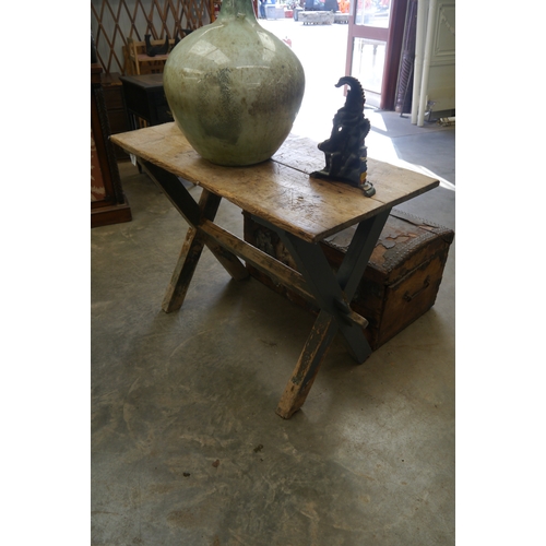2001 - A 19th Century pine X-frame tavern table on painted pegged base, 57 x 110cm