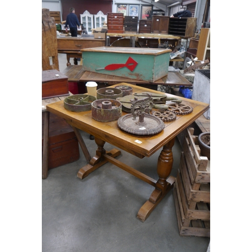2024 - A 20th Century oak draw leaf table, twin boulbous supports, stretcher base