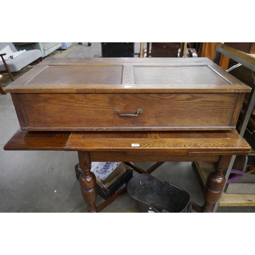 2045 - An Edwardian oak under bed blanket box with wooden wheels