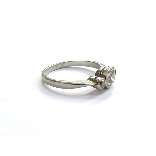 6053 - A three stone collet set diamond ring in unmarked white metal shank. Size I/J, 1.8g