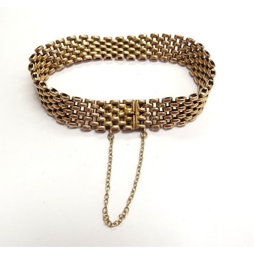 6007 - A gold articulated bracelet stamped 15ct, 18cm long, 24.2g