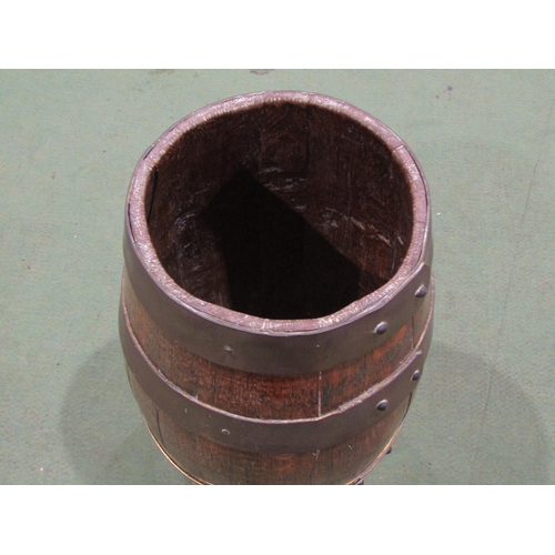 4057 - An oak brass bound coopered barrel, 34cm tall