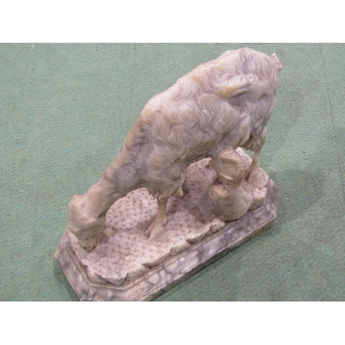 4058 - A carved alabaster figure of a grazing goat on stand, a/f repaired breaks to legs, 18cm tall