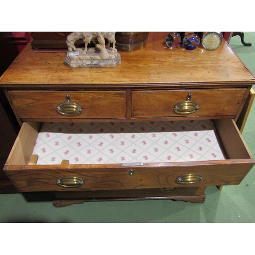 4060 - A George III figured oak chest of two short over three long drawers, oval brass handles on bracket f... 