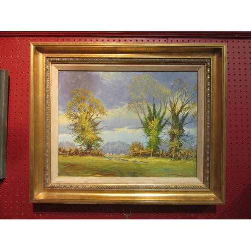 4038 - F J SAVAGE (1910-2003): An oil on board rural scene, trees, cows and fence, gilded frame, signed low... 