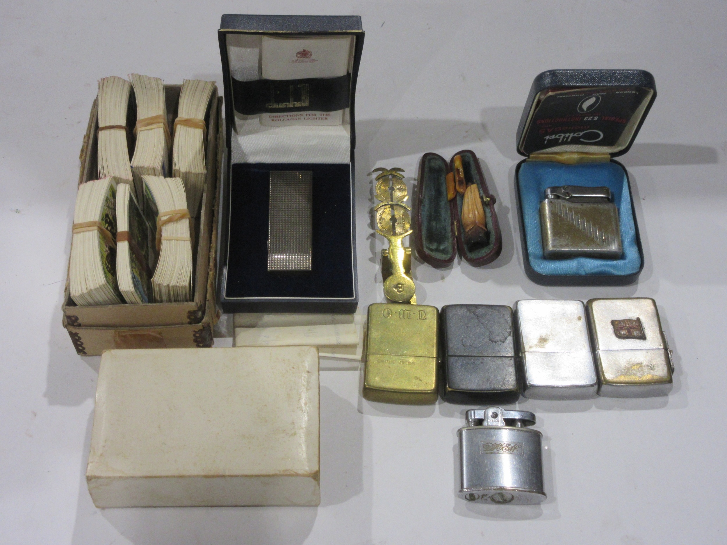 A collection of lighters including Dunhill and Zippos, cheroot holder ...