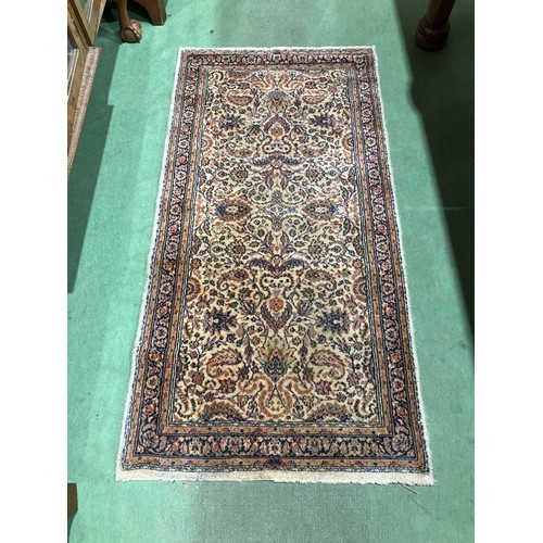 4030 - A patterned pure new wool multi-coloured ground rug, 130cm x 65cm