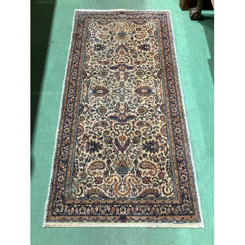 4030 - A patterned pure new wool multi-coloured ground rug, 130cm x 65cm