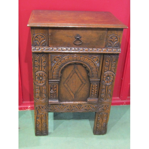 4011A - A 17th Century and later carved oak cabinet of small proportions, the single drawer over a single do... 