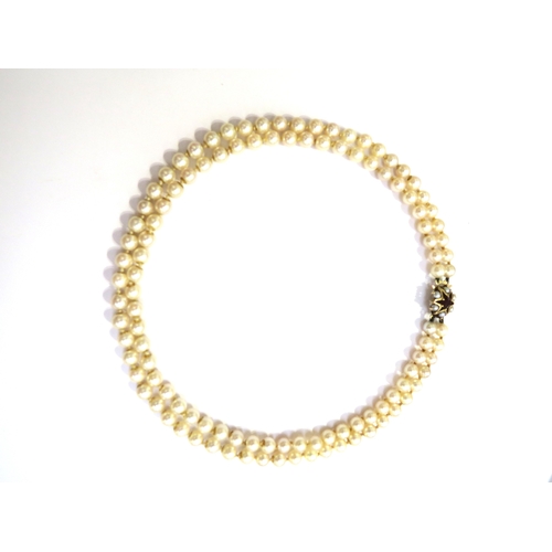 6151 - A double strand pearl necklace with a 9ct gold garnet and pearl star shaped clasp, 41cm long