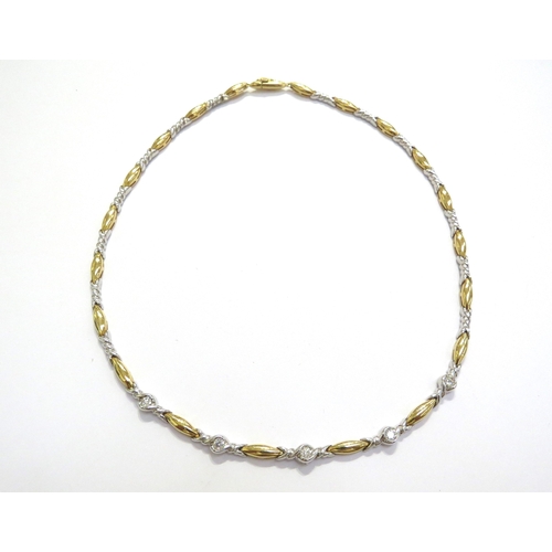 6022 - An 18ct gold necklace with alternating white and yellow gold links, five mid section white gold link... 