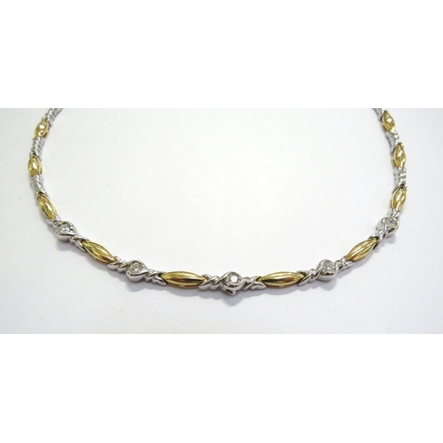 6022 - An 18ct gold necklace with alternating white and yellow gold links, five mid section white gold link... 