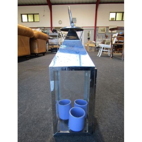 1001 - A chrome rectangular lantern with six candles and a pair of chrome lantern glass panels, loop handle... 