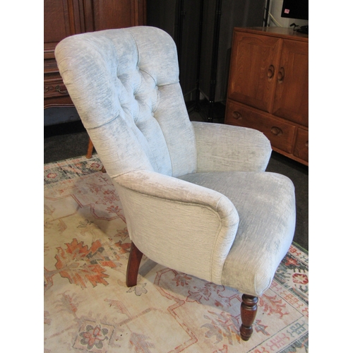 1013 - A modern button back chair with low arms