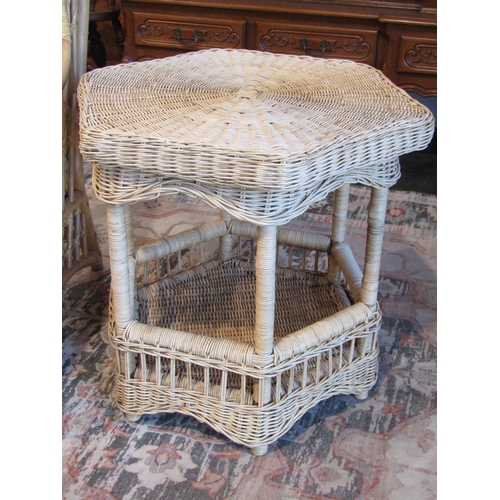 1014 - A cane armchair and cane hexagonal occasional table (2)