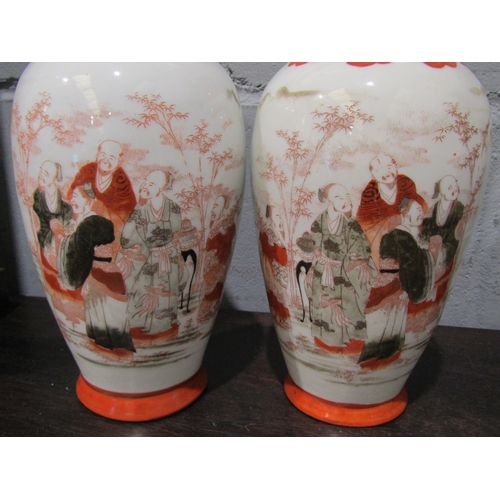 1028 - A pair of 20th Century Oriental baluster form vases, figures in garden scene, painted in enamels, gi... 