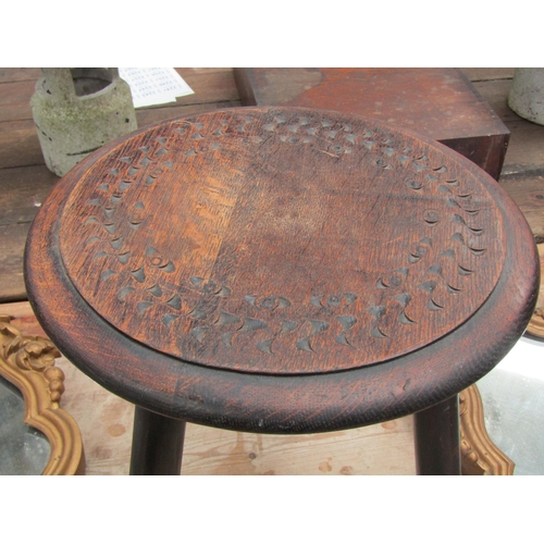 2004 - A 19th Century Oak stool, carved top on three legs