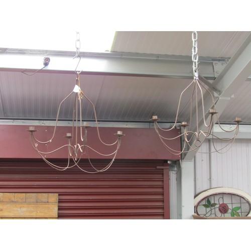 2037 - A Five arm wrought iron chandelier and a pair of four arm chandeliers