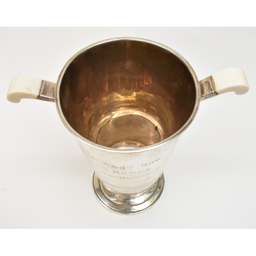 8007 - A silver presentation wine cooler ice bucket of Deco form by Barker Brothers Silver Ltd., Bakelite h... 