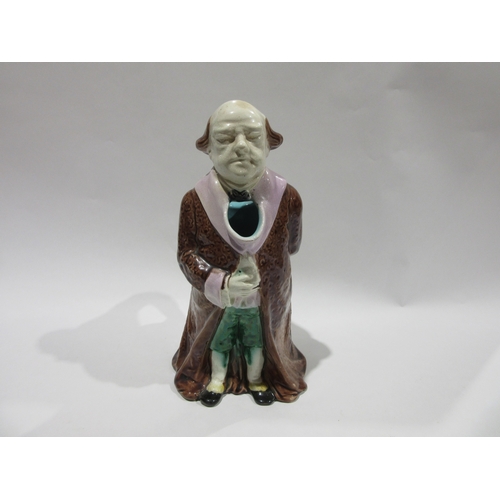 4244 - A 19th Century continental Majolica character jug, modelled as a standing gentleman attired in a lon... 