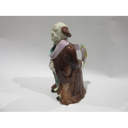 4244 - A 19th Century continental Majolica character jug, modelled as a standing gentleman attired in a lon... 