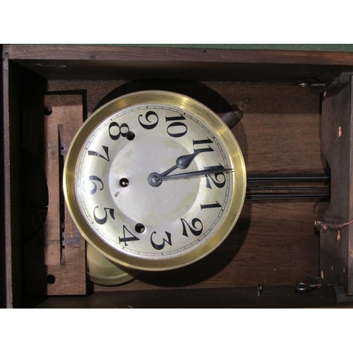 4048 - A 1940's oak wall clock, numerated chapter ring, three bevelled glass panels to base, 74cm tall, for... 