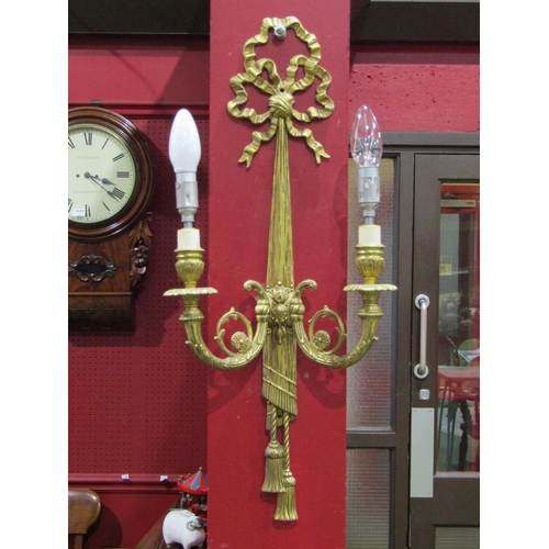 4062 - A pair of gilt metal ribbon and swag twin arm wall sconces, 60cm tall