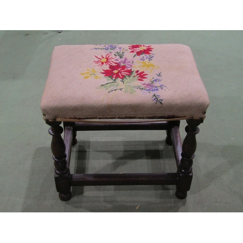 4063 - A late 19th Century oak footstool, needlepoint upholstery, turned supports joined by stretchers
