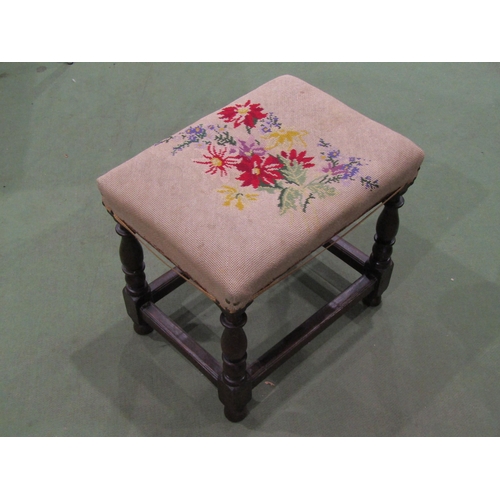 4063 - A late 19th Century oak footstool, needlepoint upholstery, turned supports joined by stretchers